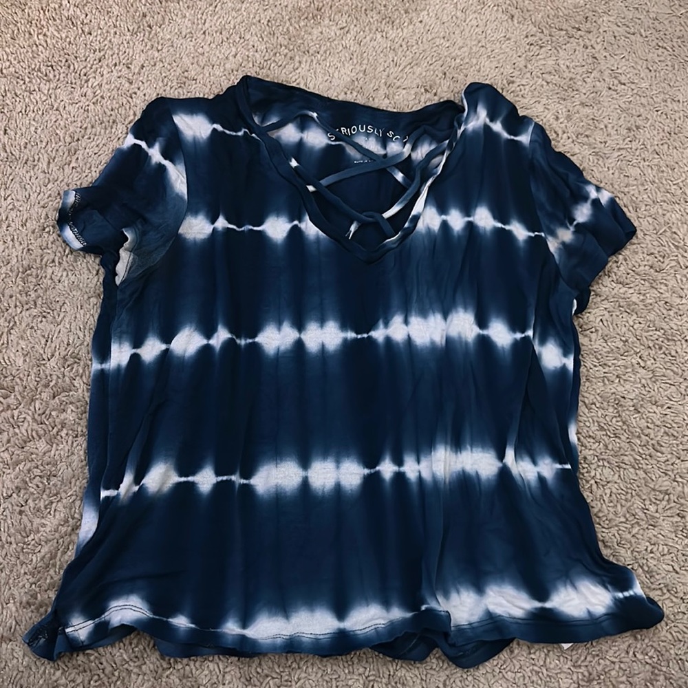 Medium blue and white womens shirt. Straps on chest.